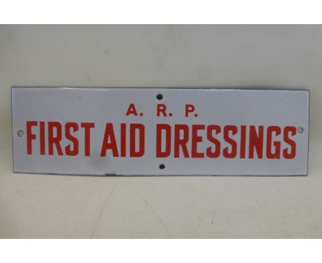 An A.R.P. First Aid Dressings narrow enamel door sign in near mint condition, 12 x 3 1/2".