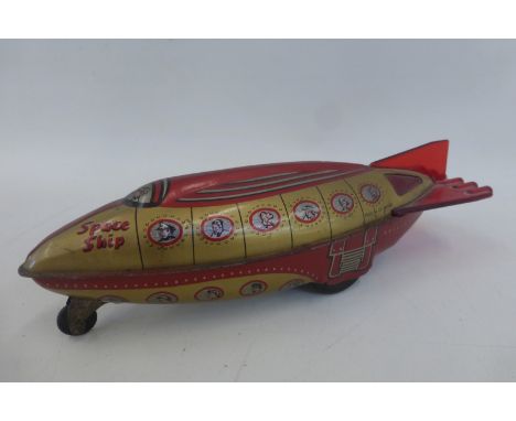 An unusual British tinplate friction operated spaceship by Wells Brimtoy. 
