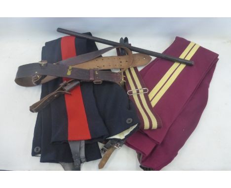 Two pairs of Kings Hussars trousers, a stable belt, a leather covered swagger stick and a Sam Browne belt with cross strap an