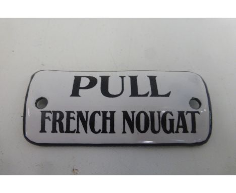 A "Pull French Nougat" convex enamel vending machine sign, 2 3/4 x 1 1/4".