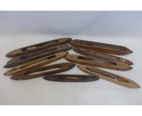 A box of wooden carpet textile cloth weaving loom shuttles.