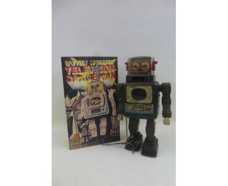 A Japanese battery operated tinplate television spaceman robot with reproduction box. 