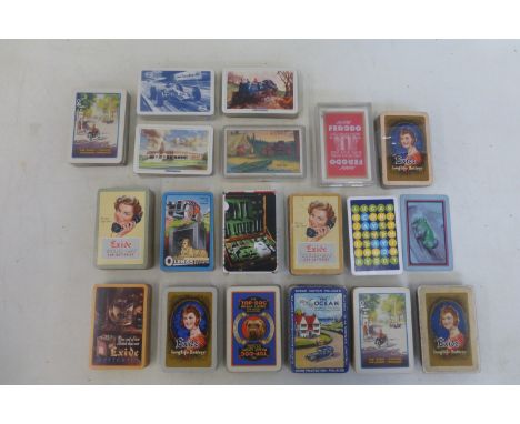 A selection of playing cards, some with advertising including 'Ocean Motor Policies', 'Exide' and 'Oldham Batteries'.