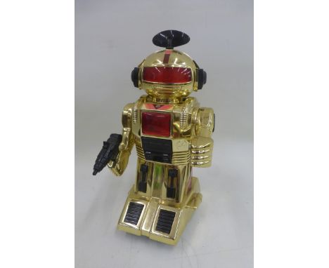 An unusual gold coloured plastic robot.