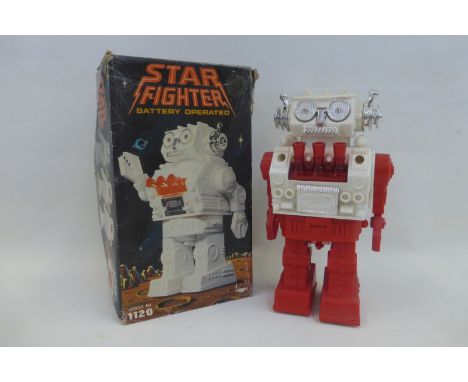 A boxed Star Fighter OR Starfighter battery operated robot, made in Hong Kong.