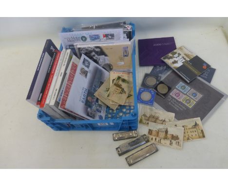 A crate of mixed stamps including a limited edition 'Return to Earth' first day cover 450/500, various postcards and commemor