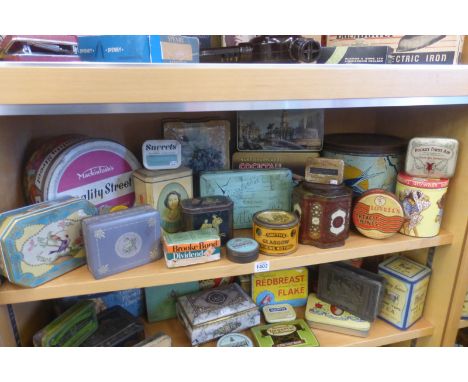 A shelf full of tins including Huntley & Palmers.