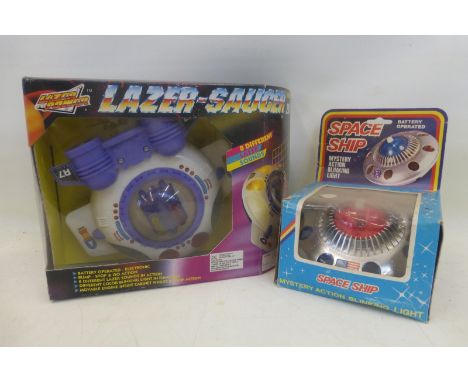 A boxed battery operated spaceship with Mystery Action blinking light, made in Hong Kong and a laser saucer by Dansette Toys.