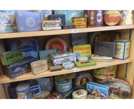 A shelf full of tins including Jacob's Biscuits.