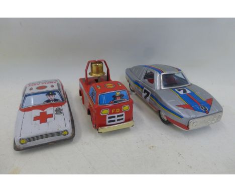 A Japanese tinplate model ambulance, a Japanese clockwork tinplate racing car and a Japanese clockwork fire engine.
