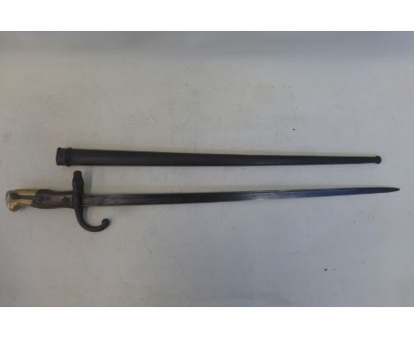 A late 19th Century French bayonet with steel scabbard.