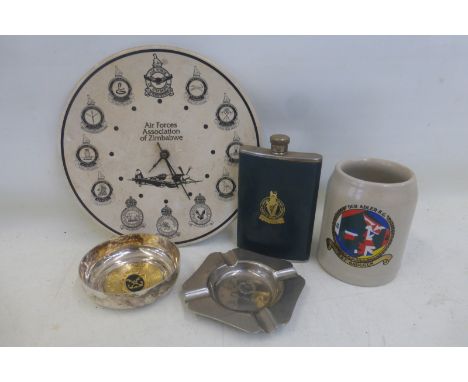 A quantity of military collectables including a Zimbabwe Air Force clock, an Irish Hussars hip flask and a tank regiment asht