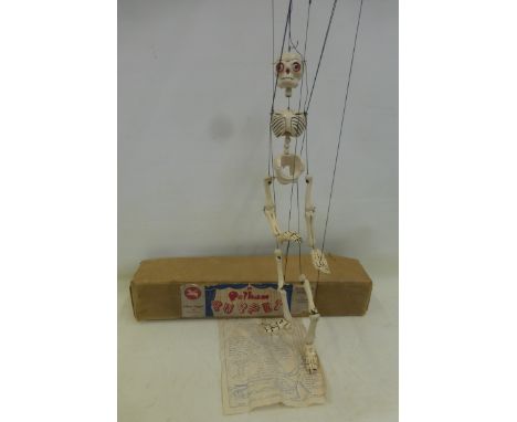A boxed 1950s 'Disjointing Skeleton' Pelham Puppet, with original instructions, bead eyes version.