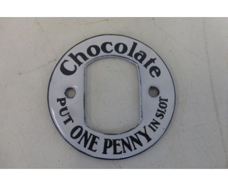 A Chocolate 'One Penny in Slot' circular enamel vending machine inscription, in mint condition, 2 1/4" diameter.