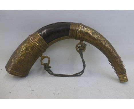 A large decorative horn and brass shot flask.