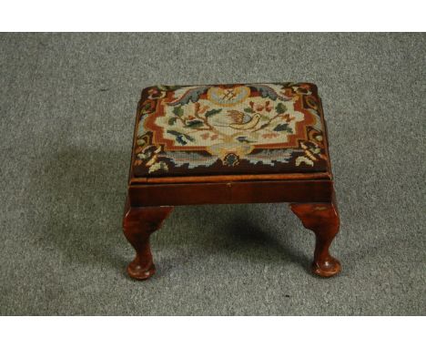 A George II style walnut footstool with tapestry upholstery. H.26 W.40 D.33cm. 