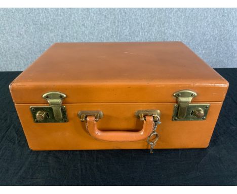 A vintage leather vanity case along with a similar smaller fitted case. H.15cm x W.35cm x D.25cm 