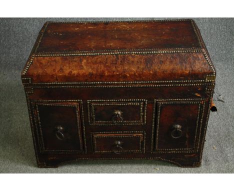 A late 19th century Continental studded leather trunk with hinged lid fitted with drawers and cupboards. H.63 W.81 D.41cm. 
