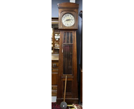 20th century oak longcase clock, silvered dial with Arabic numerals, the trunk door with bevelled glass panels, on plinth bas