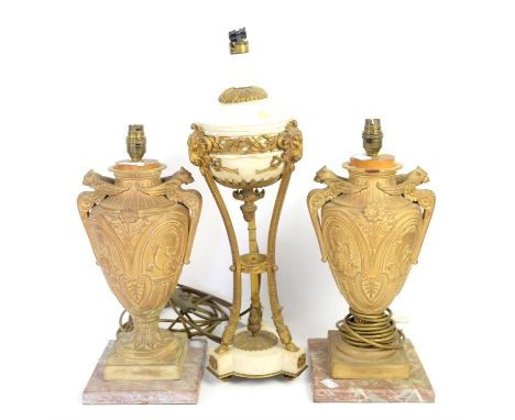 Gilt metal and marble lamp with on three supports united by shaped marble base with ram's mask mounts, 54cm high and a pair o