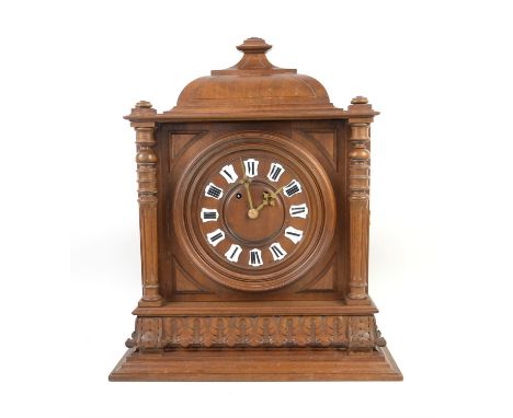 Continental walnut cased bracket clock of architectural form with pagoda top, turned reeded columns on acanthus carved plinth