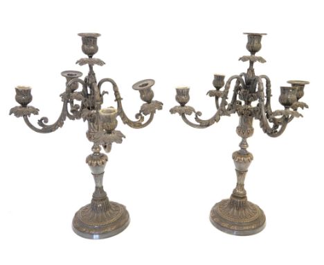 Pair of silver plated five-light candelabra with scrolling foliate arms on round feet, 45cm high,