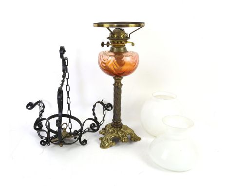Brass Corinthian column oil lamp with pink glass reservoir, four other oil lamps and various shades