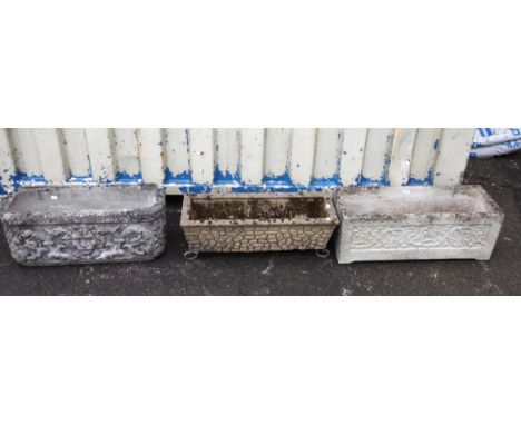 Three reconstituted stone planters, comprising one with lion mask and scrolling floral decoration, h29cm w71cm d26cm, a recta