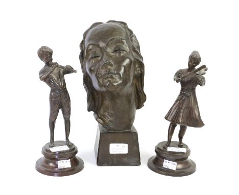 Cast resin bust of a young woman together with a pair of cast metal figures of young musicians 