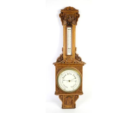 20th century oak barometer, with thermometer and barometer in oak cased with carved eagle and scrolling floral decoration, h9