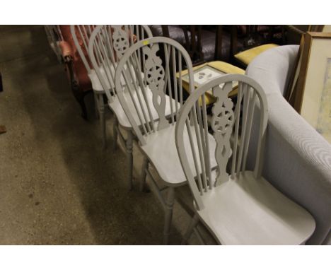 A set of four painted stick and wheel back dining chairs