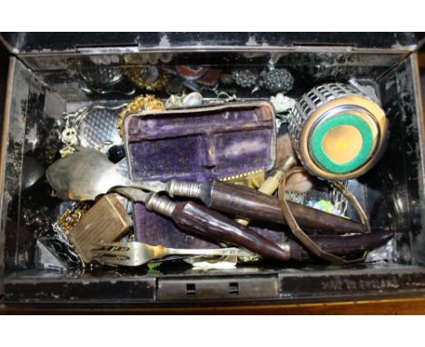 A cash tin and contents of cutlery, costume jewellery, a table lighter etc. 