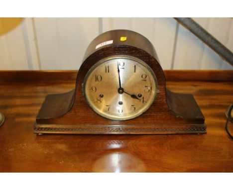 An oak three hole mantel clock 