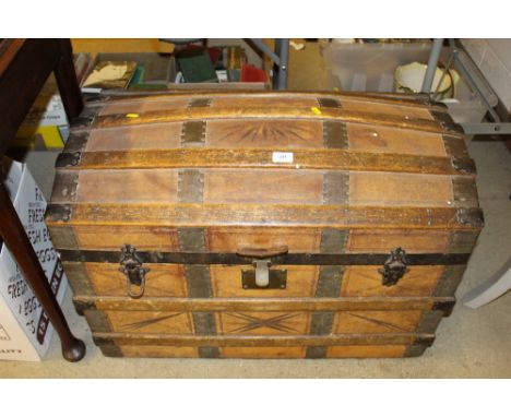An oak bound and leather dome topped travelling trunk 