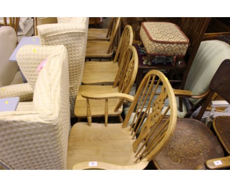 A set of five stick and wheel back pine dining chairs ro include one carver  