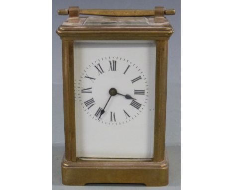 Early to mid twentieth century brass carriage clock in corniche style case, the white enamel Roman dial with blued spade hand