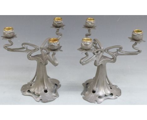 A pair of Art Nouveau pewter three branch candelabra in the style of Archibald Knox, height 26cm