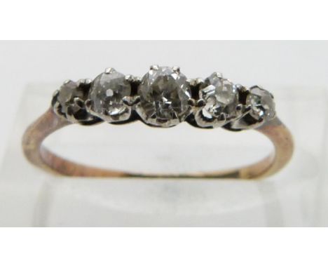 An 18ct gold ring set with five diamonds, size K