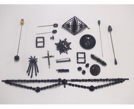 A collection of jet jewellery including brooches, Victorian stick pin set with a pearl, buckles, pendant, pins, Victorian cro