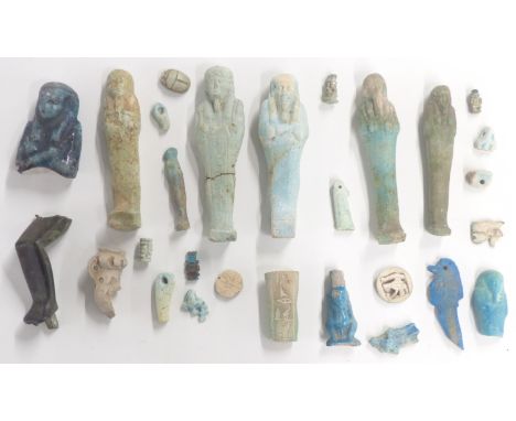A quantity of Egyptian Shabti figures, amulets, bronze statue part etc