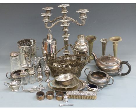 A quantity of silver plate including candelabra, cocktail shakers, teapot, hallmarked silver pepper, silver mounted sugar cas