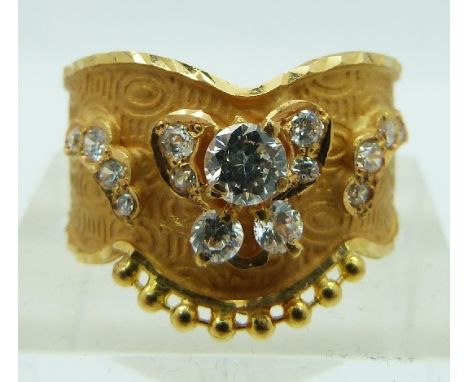 A yellow metal Indian ring set with cubic zirconia, 3.2g, size R