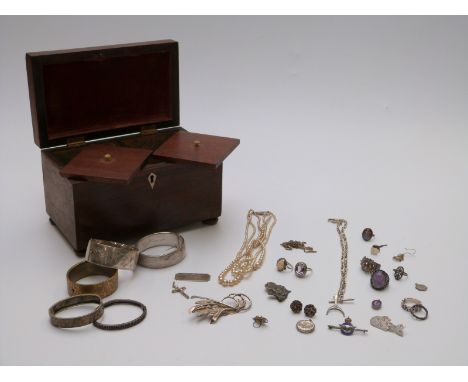 A collection of silver jewellery including Edwardian bangle, another bangle Chester 1957, silver rings etc., all in a tea cad
