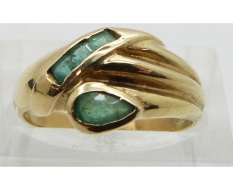 A 14ct gold ring set with emeralds in a stylized snake design, size K/L