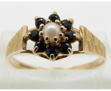 A 9ct gold ring set with a pearl surrounded by sapphires, size R