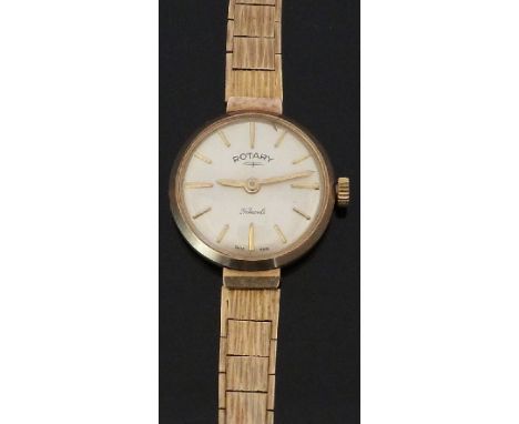 Rotary 9ct gold ladies wristwatch with gold hands and baton markers, silver dial, and signed 21 jewel movement, on 9ct gold b