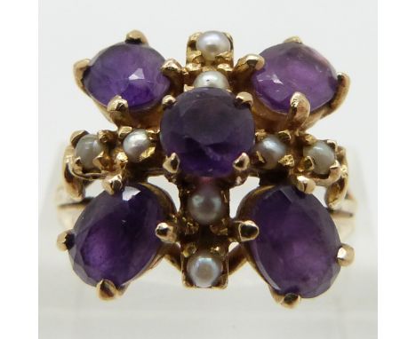 A 9ct gold ring set with oval amethysts and seed pearls, size R