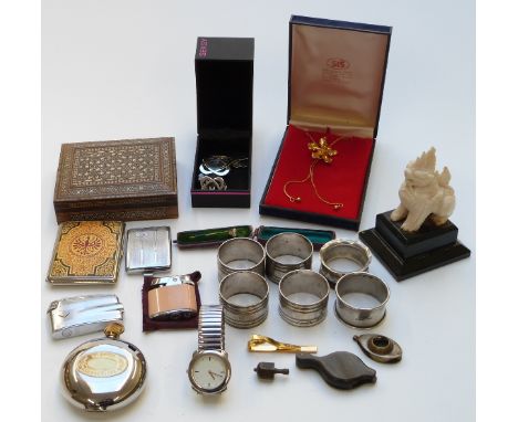 A collection of items including a Vizagapatam box, a carved figure, napkin rings, a Ronson lighter depicting a poodle, anothe