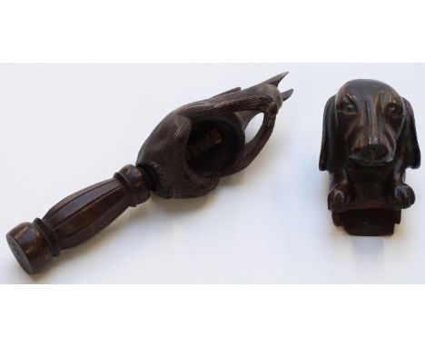 Black Forest carved squirrel nutcracker and a carved Dachshund wall mask, longest 20cm.