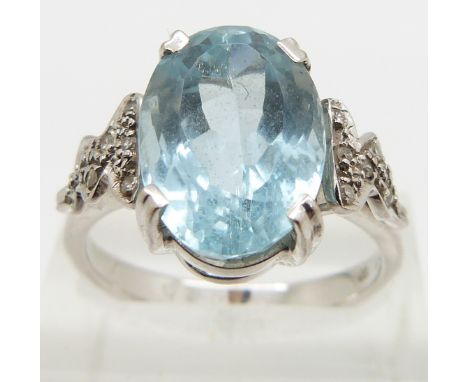 An 18ct white gold ring set with an oval mixed cut aquamarine and diamonds to the shoulders, size Q/R